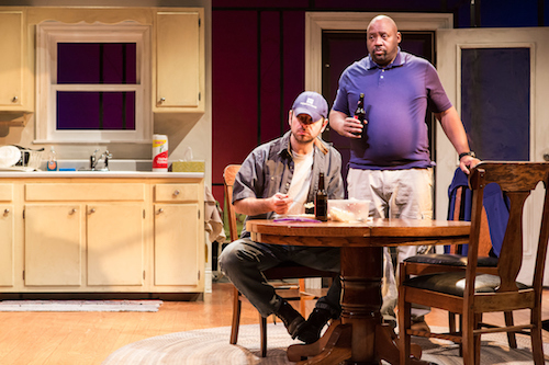 Actor David Bendena eats at the dinner table and Actor Lynch Travis drinks a beer